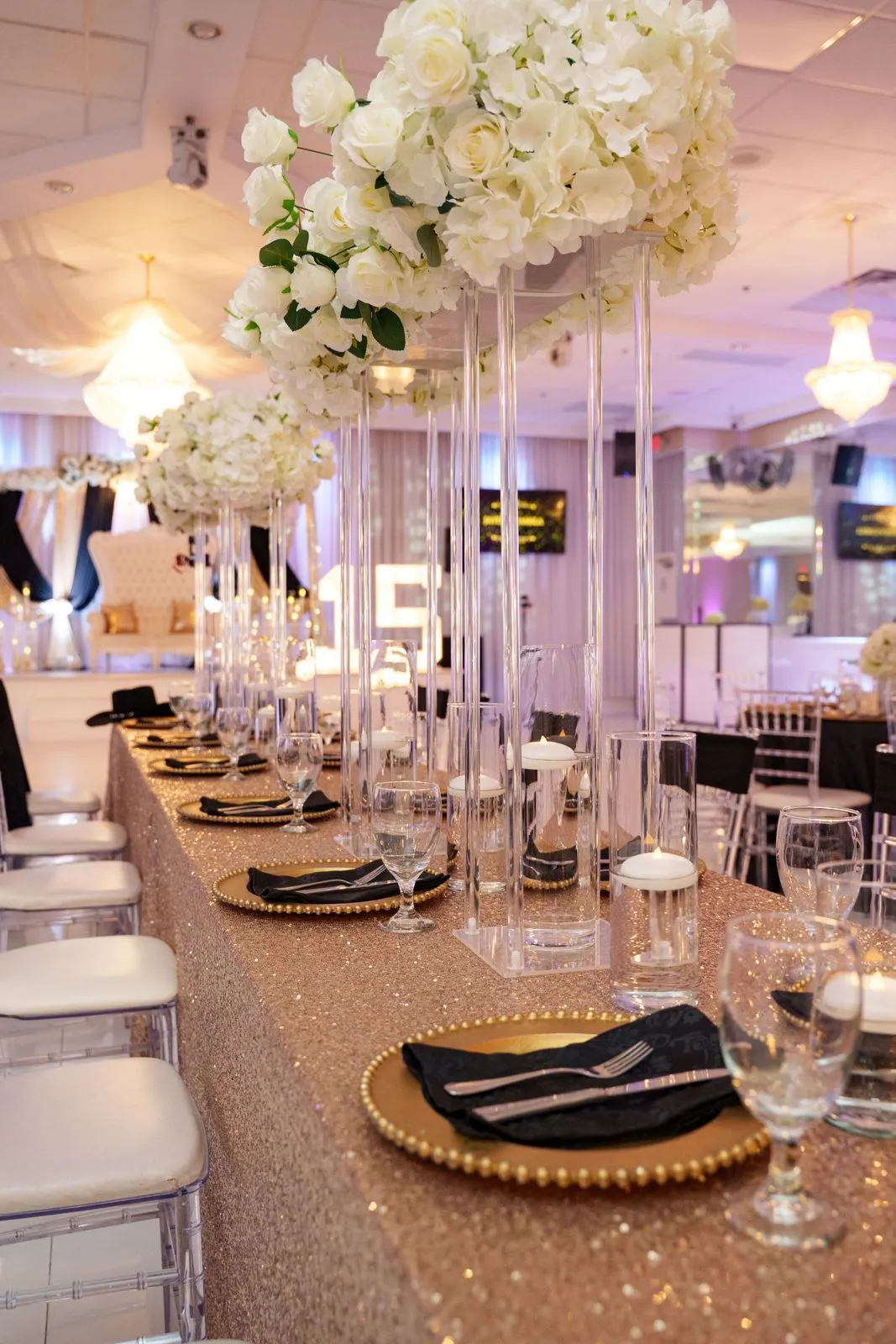 An elegant head table at Luxor Banquet Hall dressed with gold and white florals