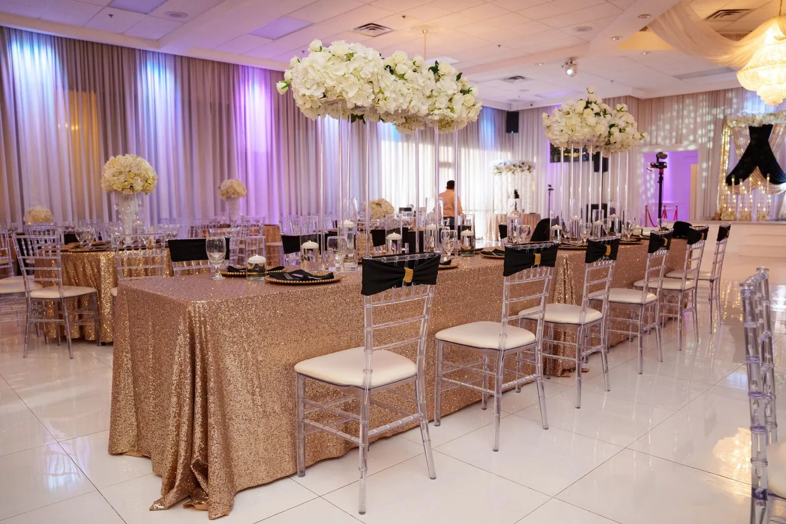 A reception table at Luxor Banquet Hall with clear chiavari chairs